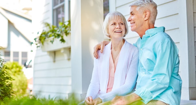 Happy senior couple sitting on porch