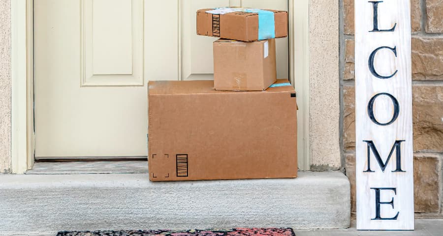 Deliveries on the front porch of a house with a welcome sign